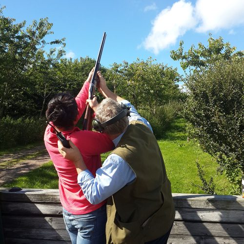 Instructor,Teaching,Girl,Clay,Pigeon,Shooting Instructor teaching girl clay pigeon shooting
